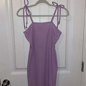 tight fitting dress with a slit on the left side.